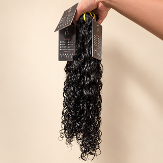 The Allure Premium Virgin Burmese Curly bundle on warm cream background
